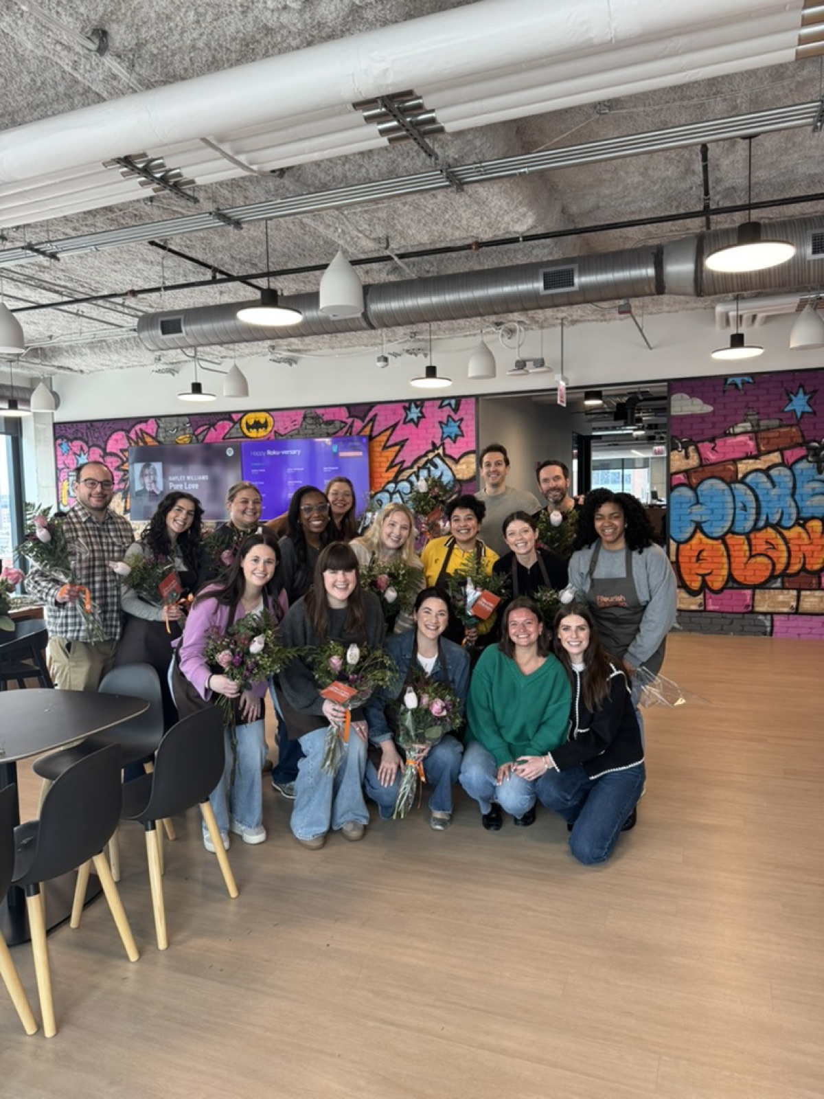 Corporate team holding hand-tied bouquets after a Fleurish Chicago workshop event