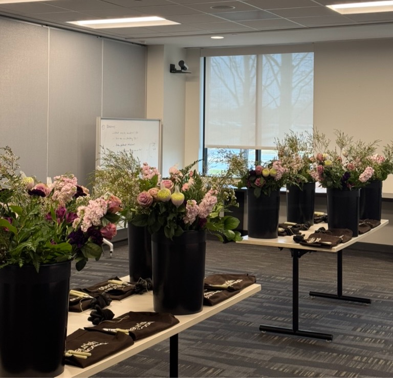 Corporate event with bouquets arranged on tables for an in-office workshop