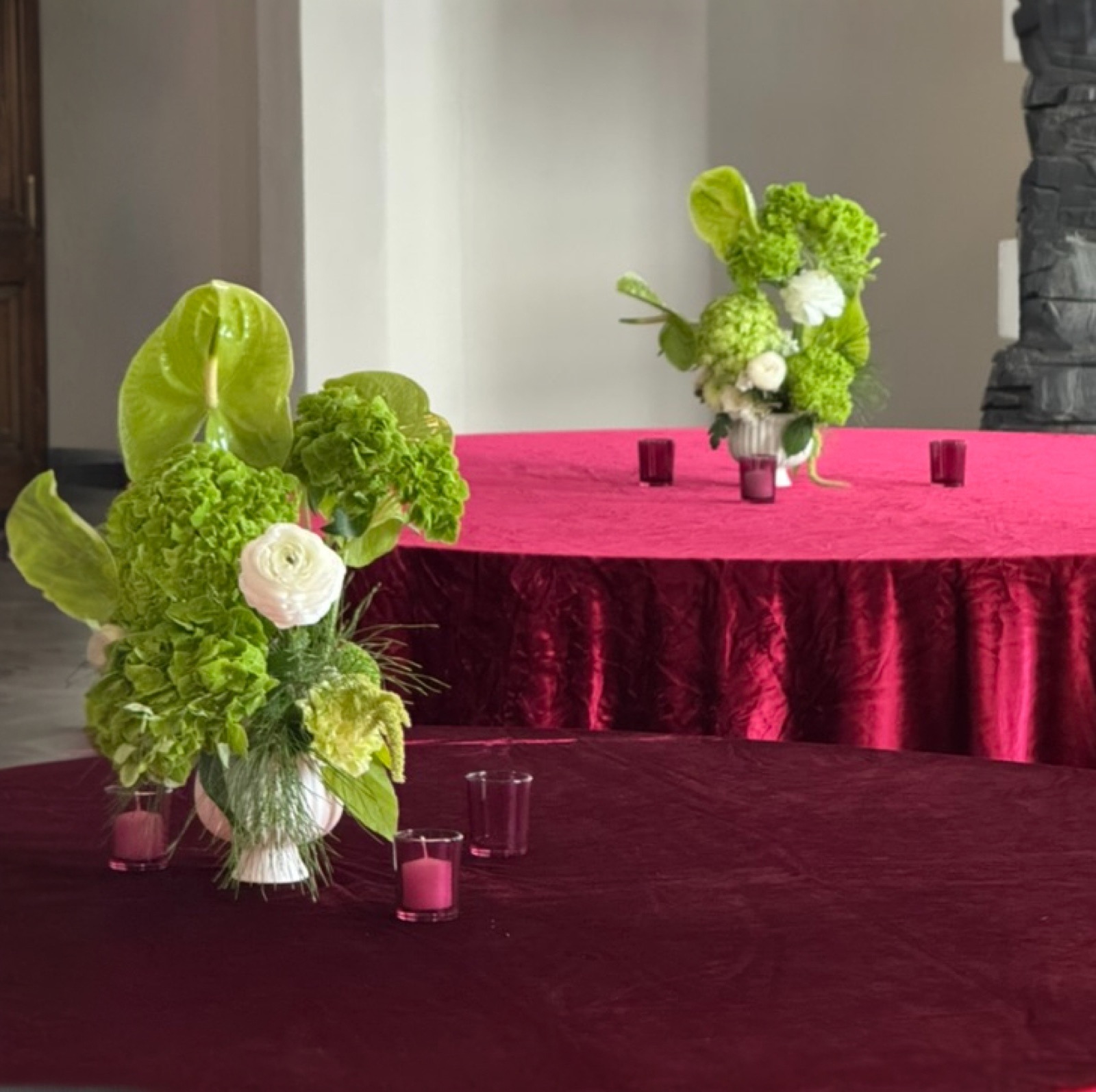 Magenta velvet tablescape with green-and-white centerpieces